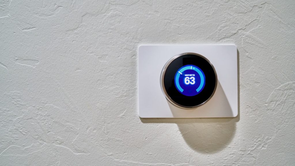 A smart thermostat mounted on the wall